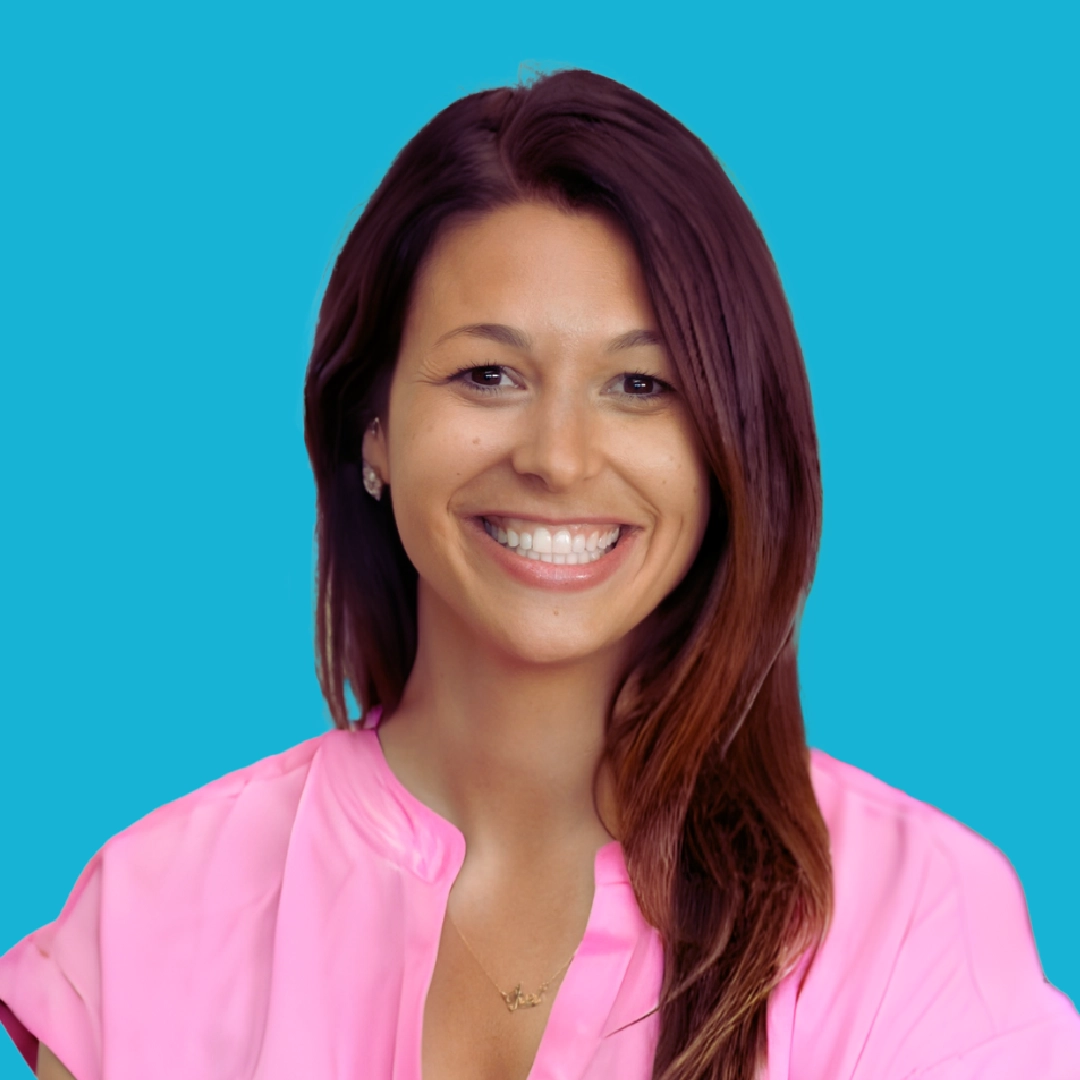 Portrait of a woman with long brown hair wearing a pink shirt smiling against a bright teal circular background.
